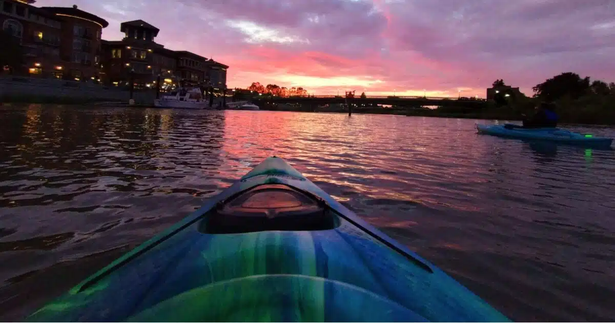 Napa sunset kayak tour on the Napa River beneath colorful downtown skies