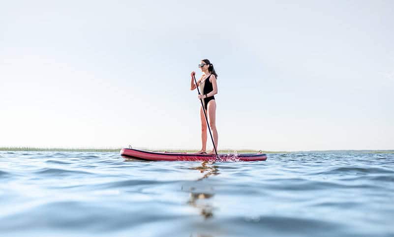 a girl paddling a paddleboard rental in napa
